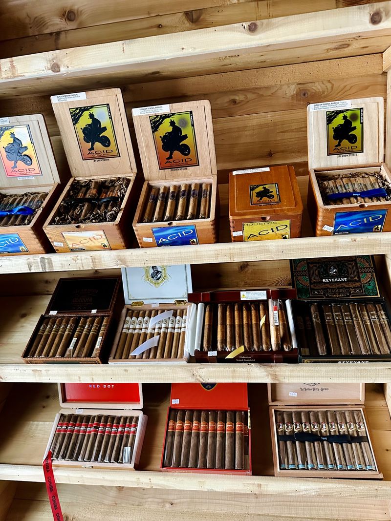 Cigar boxes on cedar shelves at Spark & Smoke in Wylie, TX